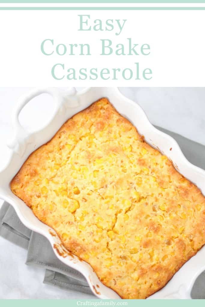 QUICK & EASY CORN BAKE CASSEROLE RECIPE and a white and pink casserole on a gray towel on a marble white counter.