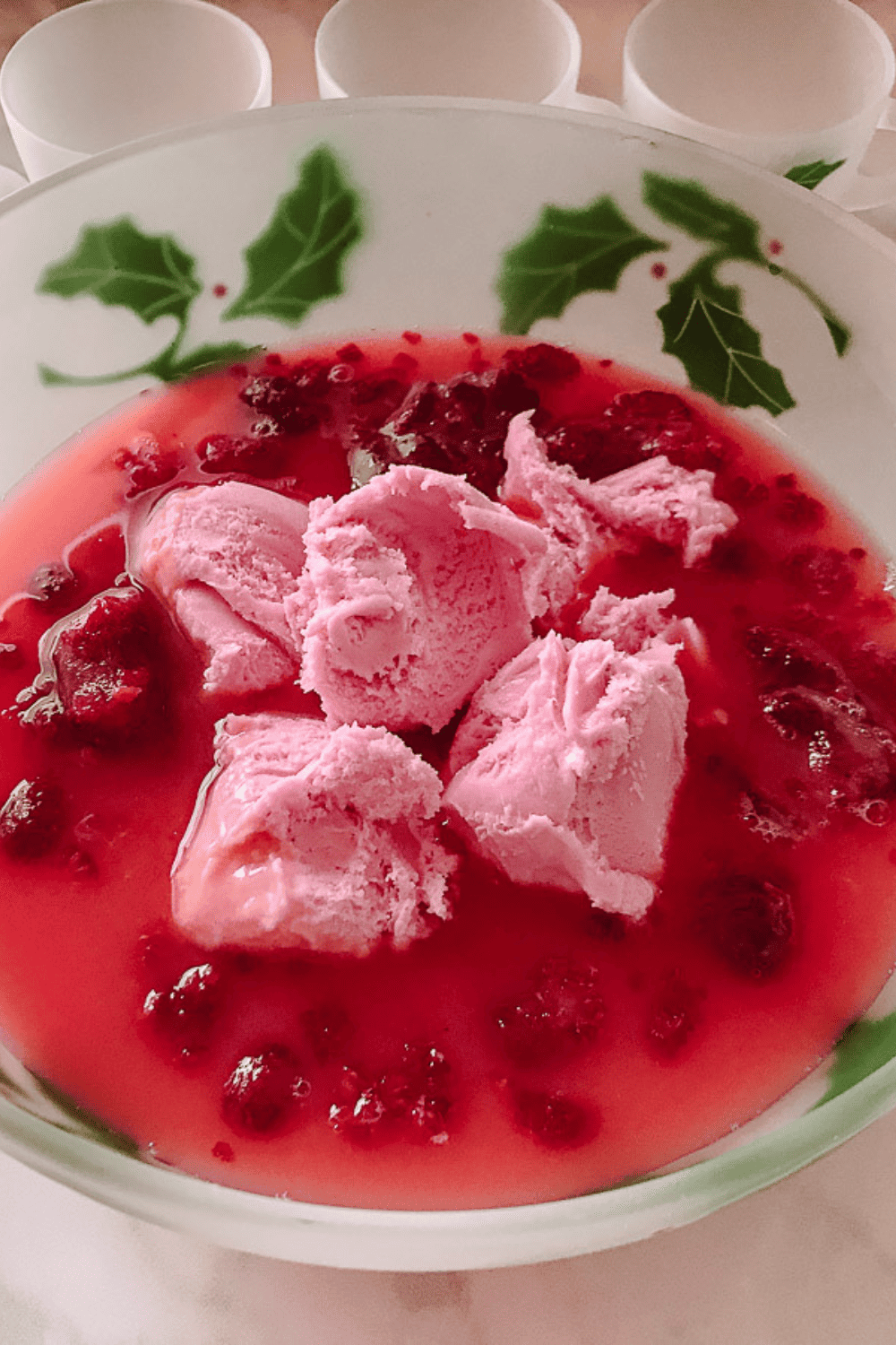 Delicious Holiday Raspberry Sherbet Punch Non Alcoholic top view of the punch and sherbet in the christmas holly designed punch bowl.