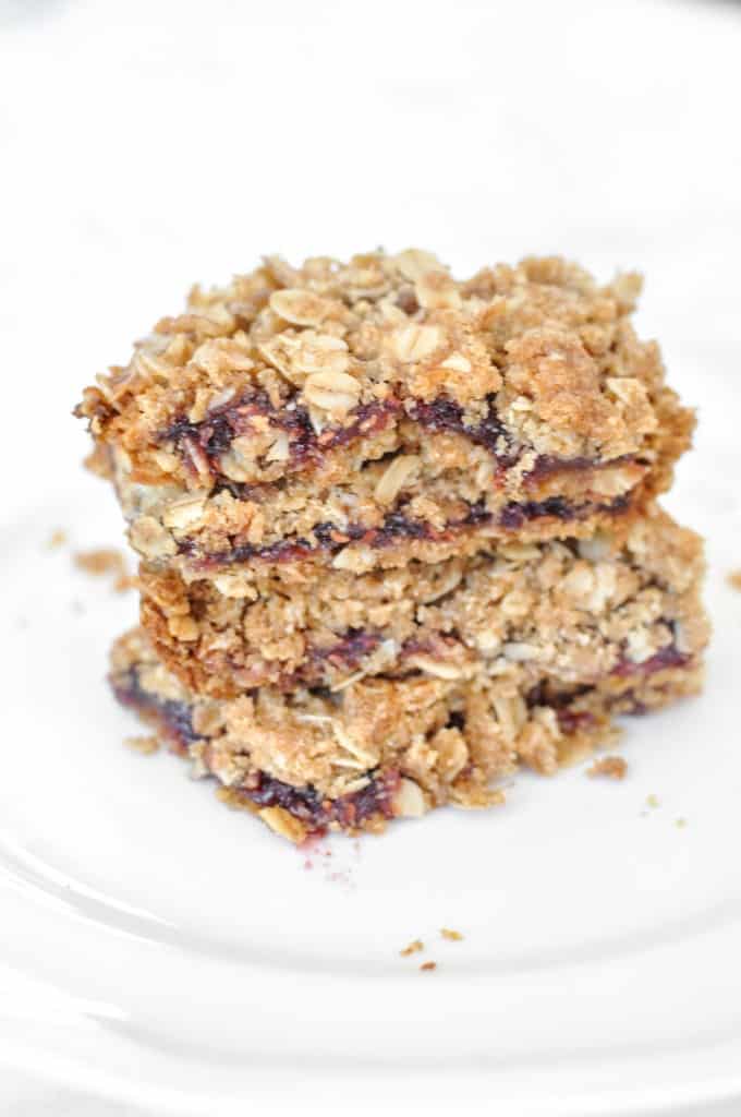 5 Homemade After School Snacks Raspberry Oatmeal snack bars on a white plate.