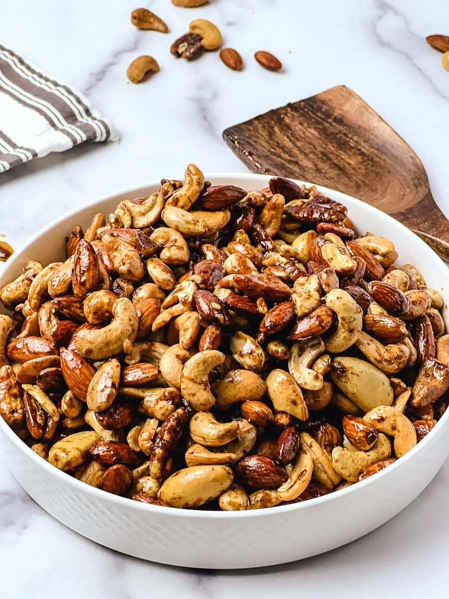 Easy spiced nuts recipe in a white bowl ready to serve at a holiday party