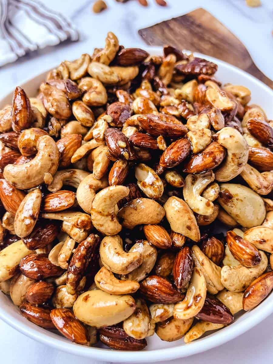 Close up of glossy sweet and spicy roasted nuts with cashews, almonds and pecans