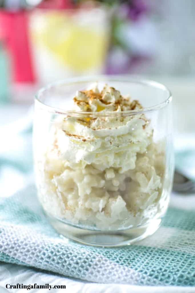 Rice pudding in the instant pot in clear cup on blue green napkin