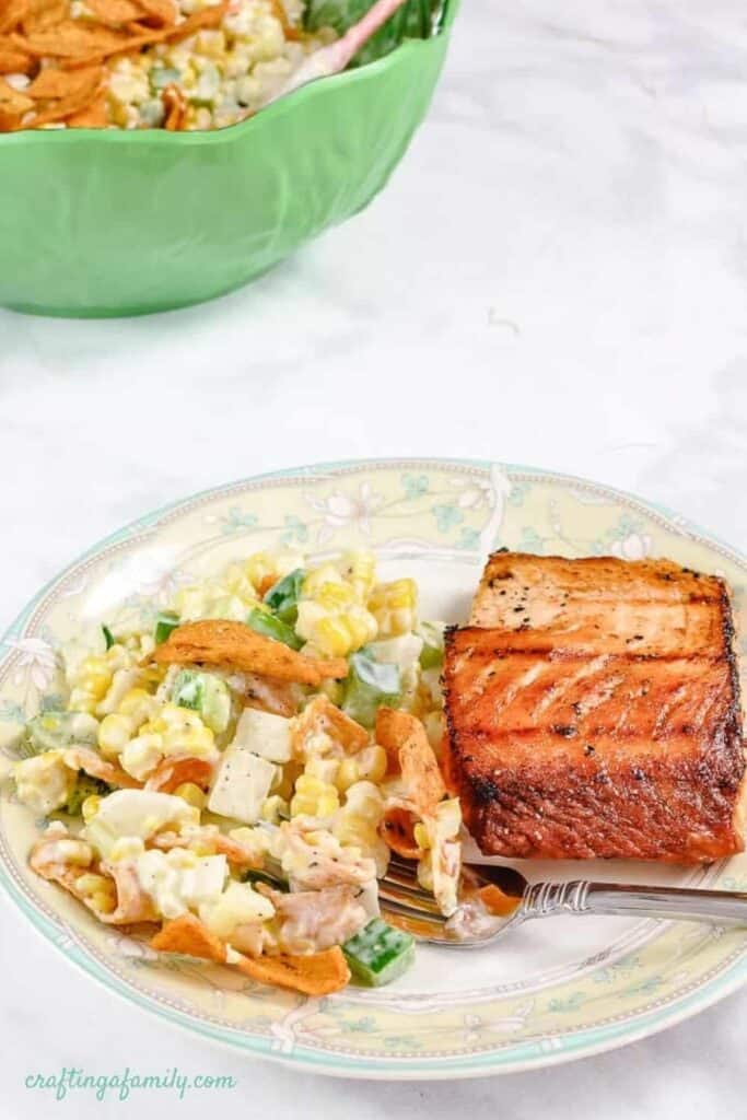 freto corn salid on a plate with salmon