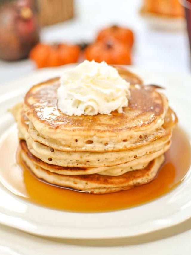 Easy Bisquick Pancake Recipe: Ultimate Apple Cinnamon stack of pancakes on a white plate. 