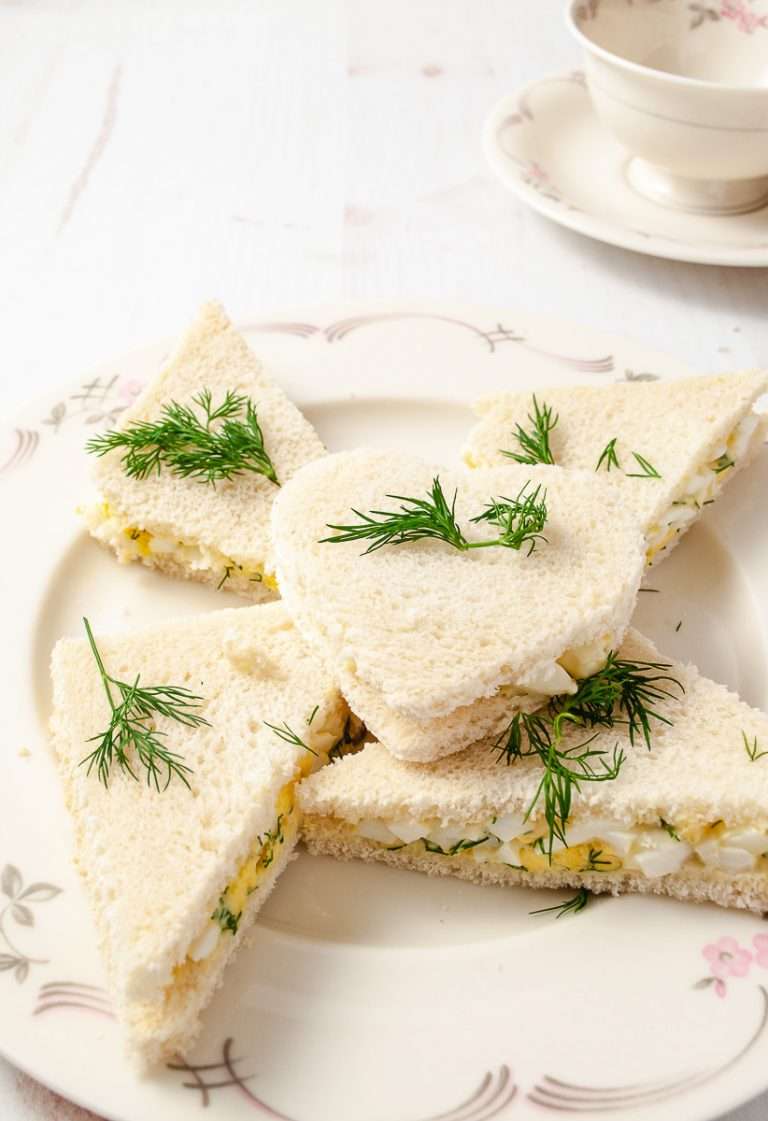 4 triangle square and one heart mini sandwich on whit plate