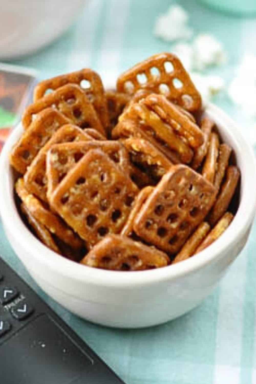 movie pretzels in a round pink bowl on a green table cloth.