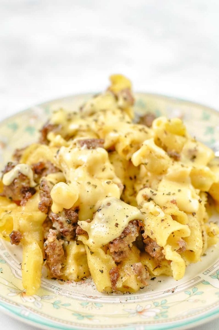 Cheeseburger Mac and Cheese Casserole – no tomato sauce on a yellow and green flowered rim plate on a white counter. 
