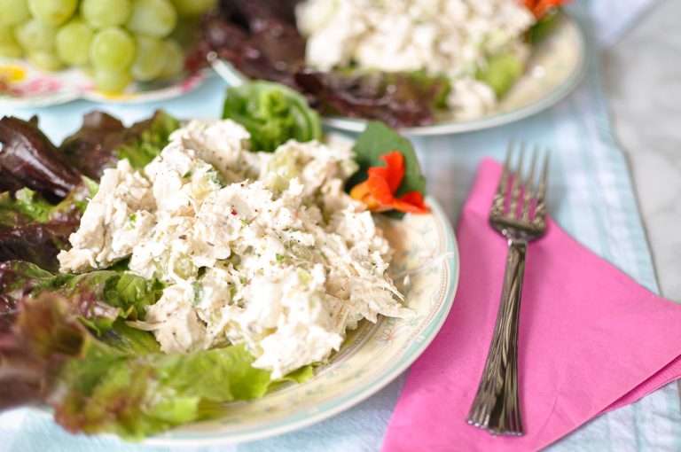 Instant Pot chicken salad on lettuce, grapes and with red flower silver fork pink napkin