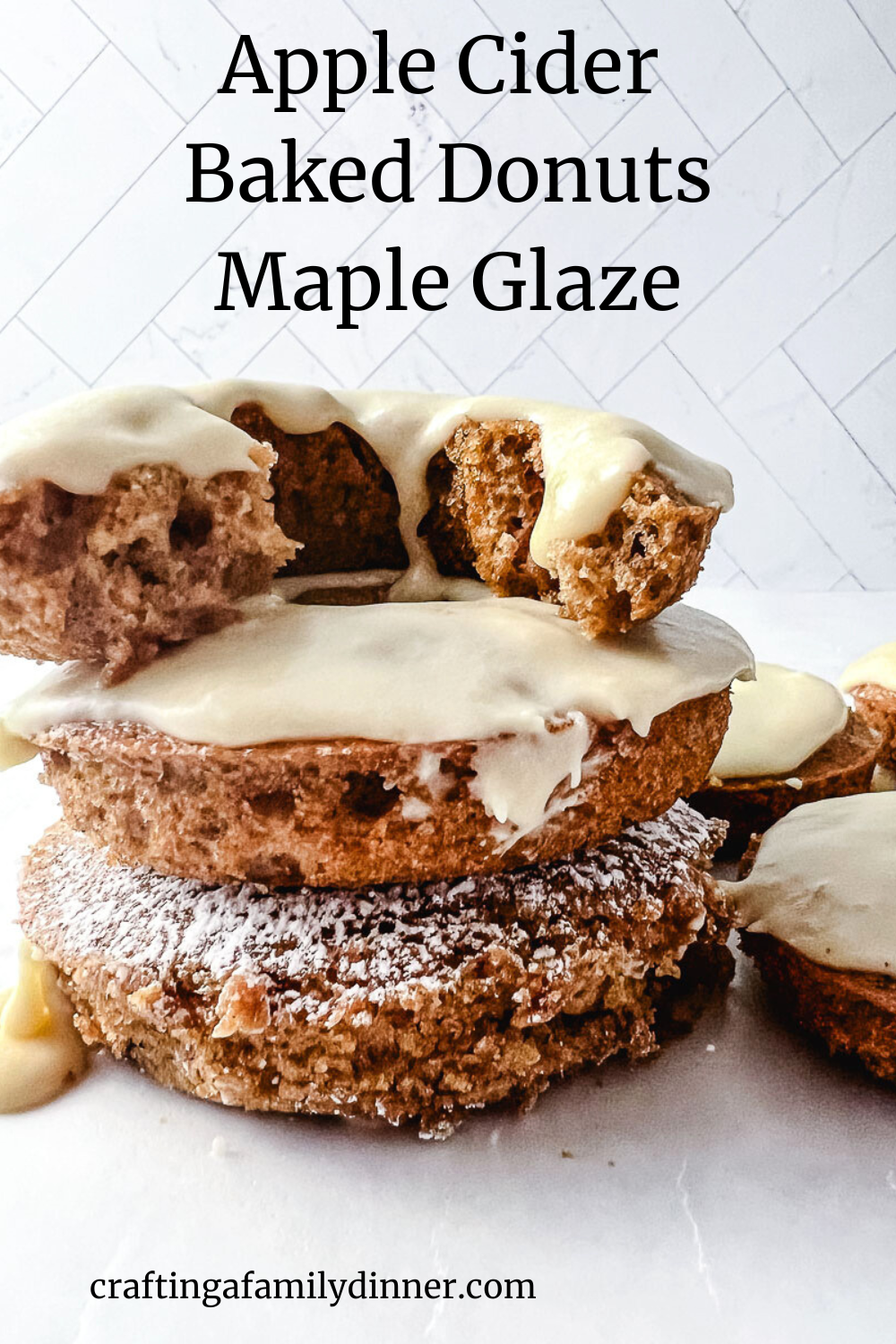 apple cider baked donuts maple glaze on a white counter. 
