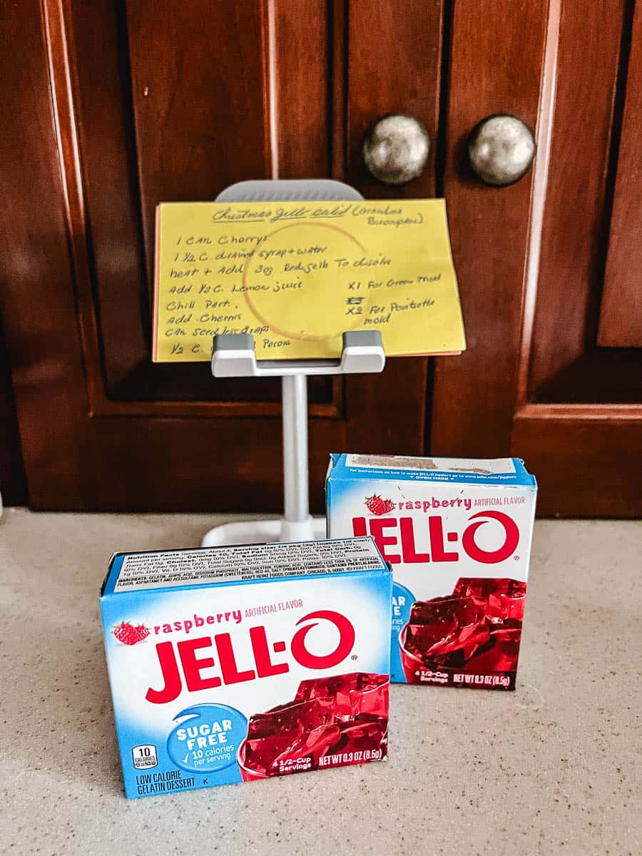 2 raspberry jello boxes on counter with the original recipe card from Grandma Grace Buonpane