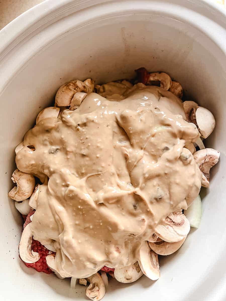 cream of mushroom soup mixture with onion soup mix on top of all of the ingredients.