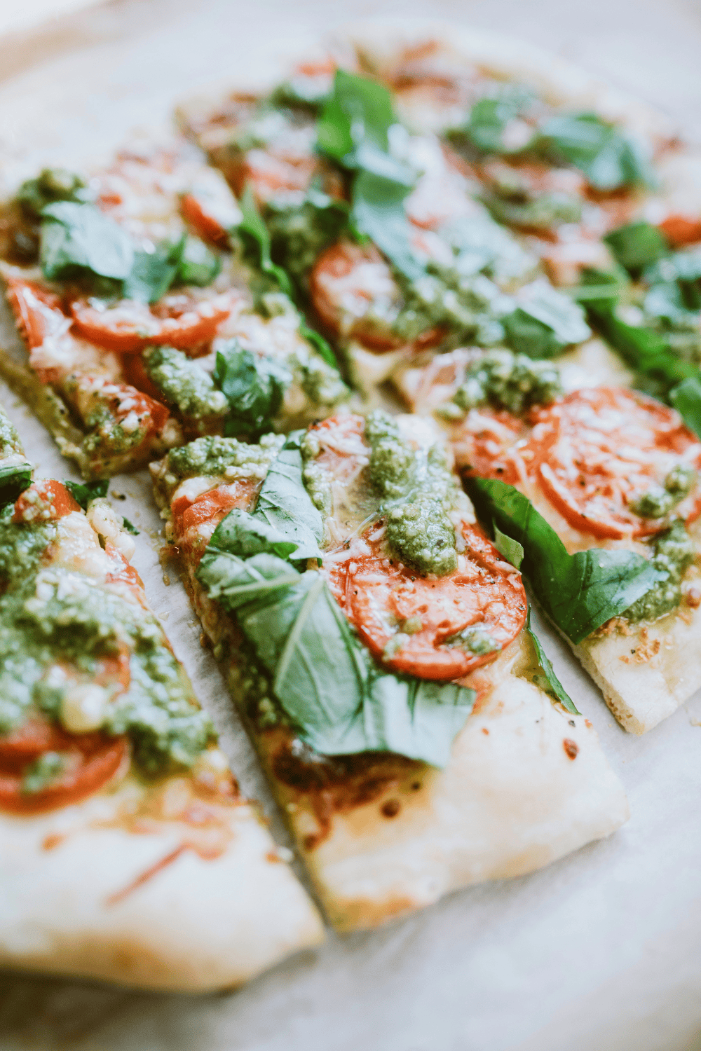 Homemade Fresh Italian Basil Pesto with Walnuts, a pesto pizza with pesto ontop of tomatoes and fresh basil leaves.  