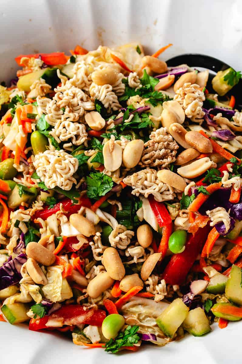 thai crunch salad close up of all the veggies with peanuts and ramen noodles on top.
