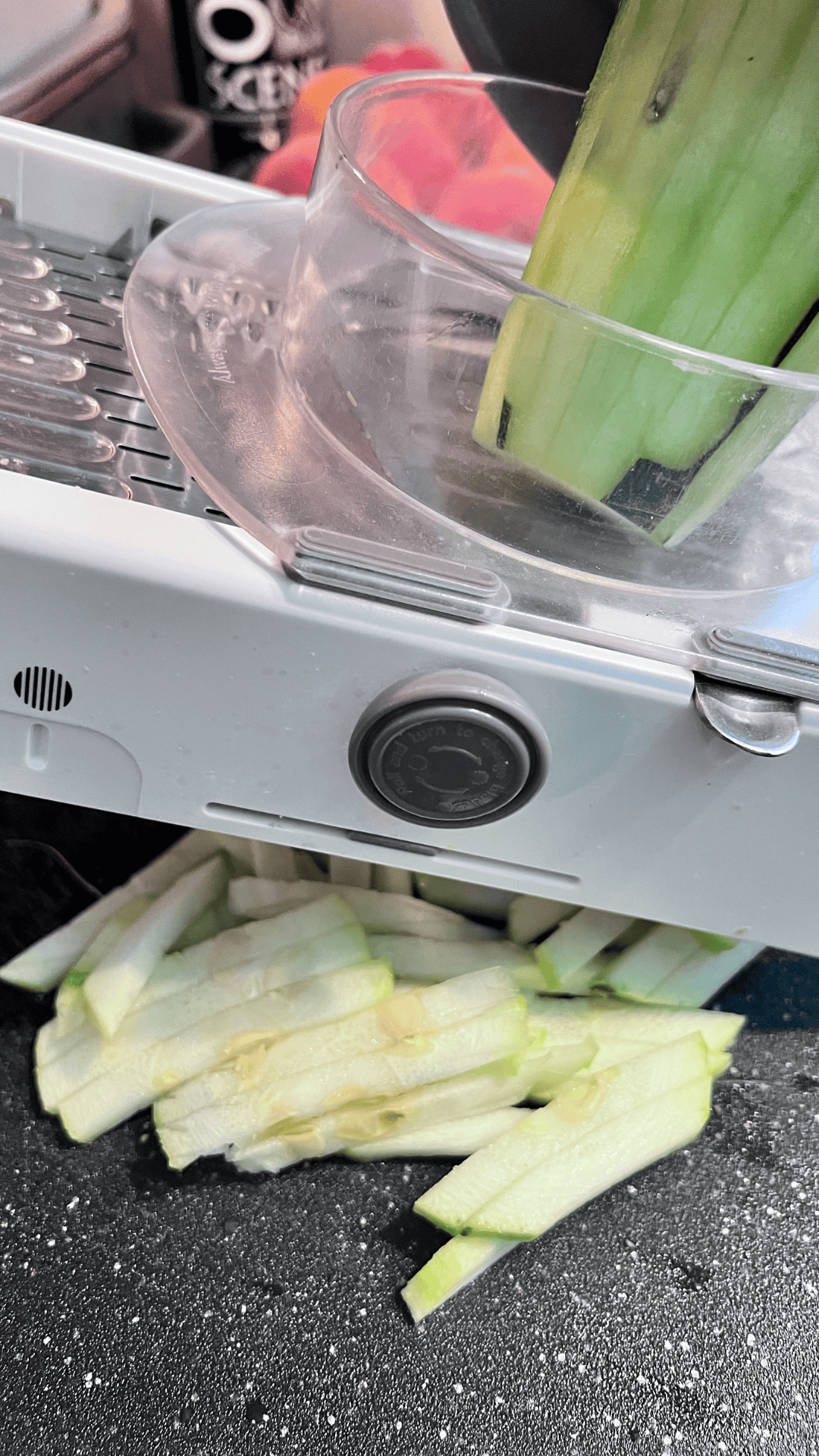 Easy Ground Beef Zucchini Skillet Casserole  slicing into matchstick a zucchini on a hand mandoline. 