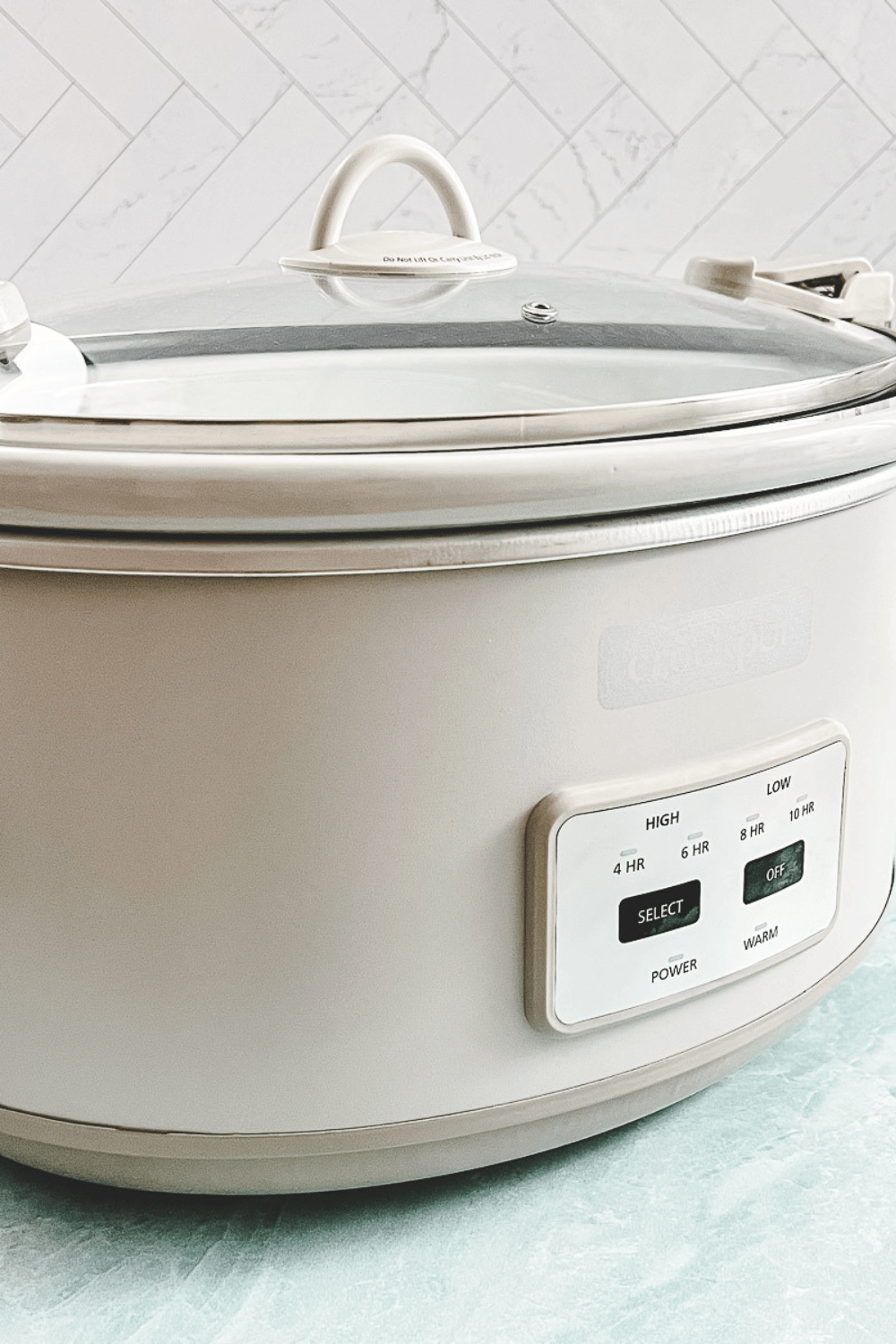 cream crockpot in a white kitchen.