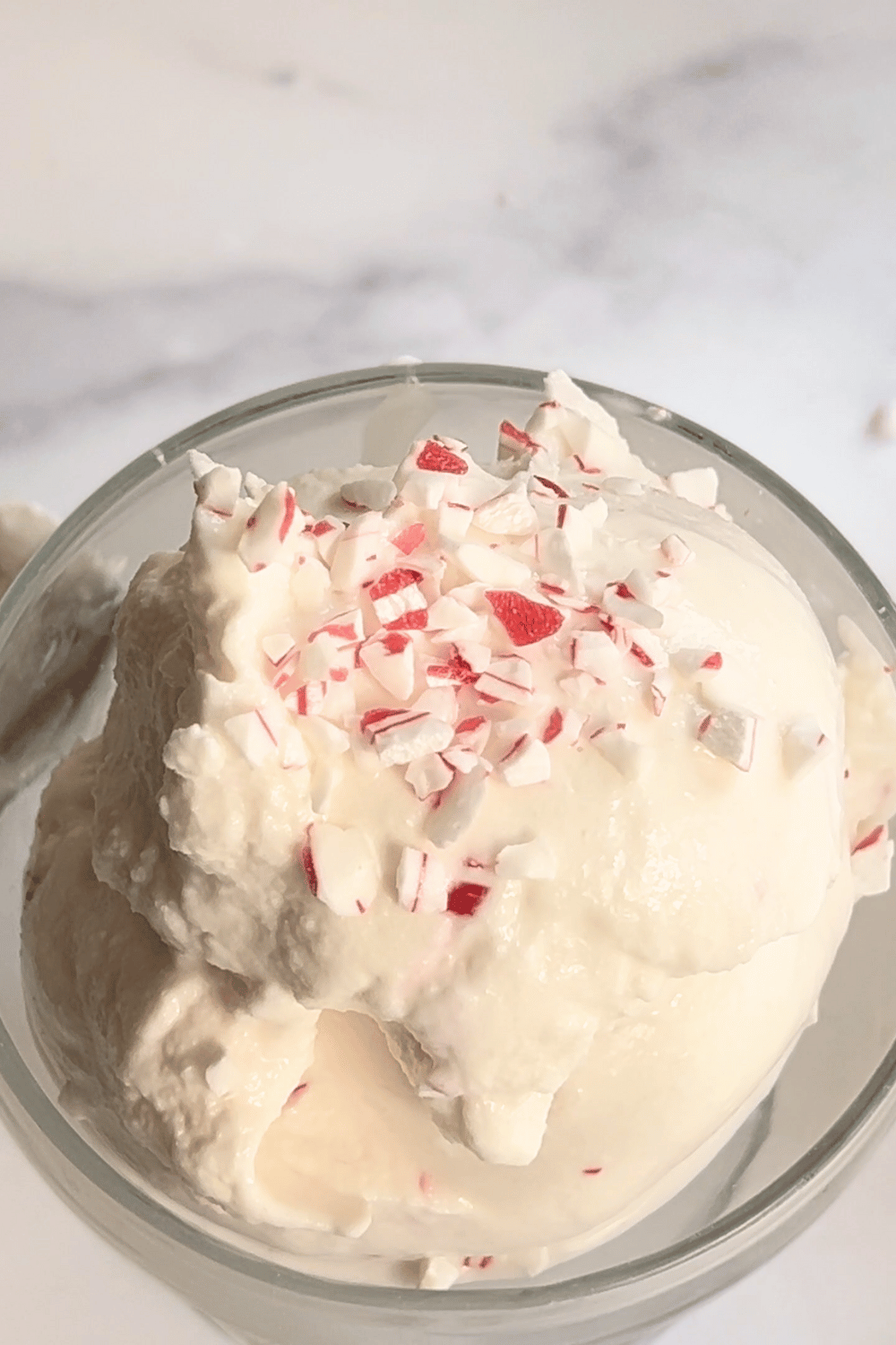 top down view of Ninja Creami Peppermint Ice Cream Holiday Treat view of the top of the scooped ice cream with crushed candy canes. 