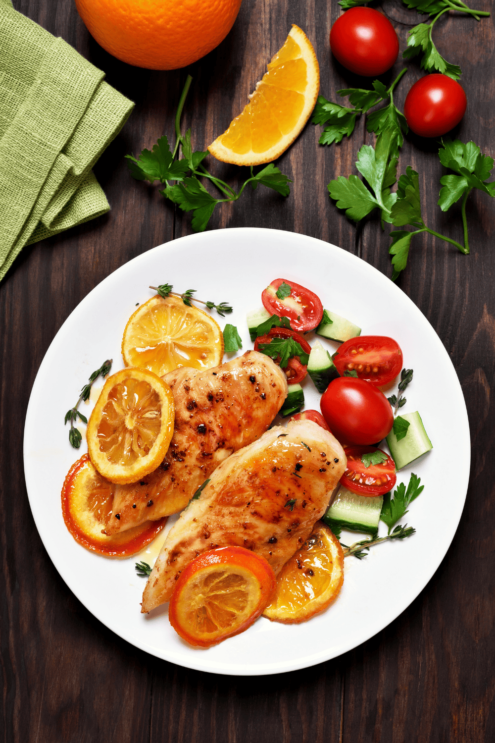 Grilled chicken breasts glazed in a golden orange chicken marinade, garnished with slices of fresh orange and served alongside a crisp cucumber and tomato salad. This bright and juicy citrus chicken marinade combines sweet orange juice chicken marinade flavor with a hint of spice, perfect for a zesty orange ginger chicken dinner.