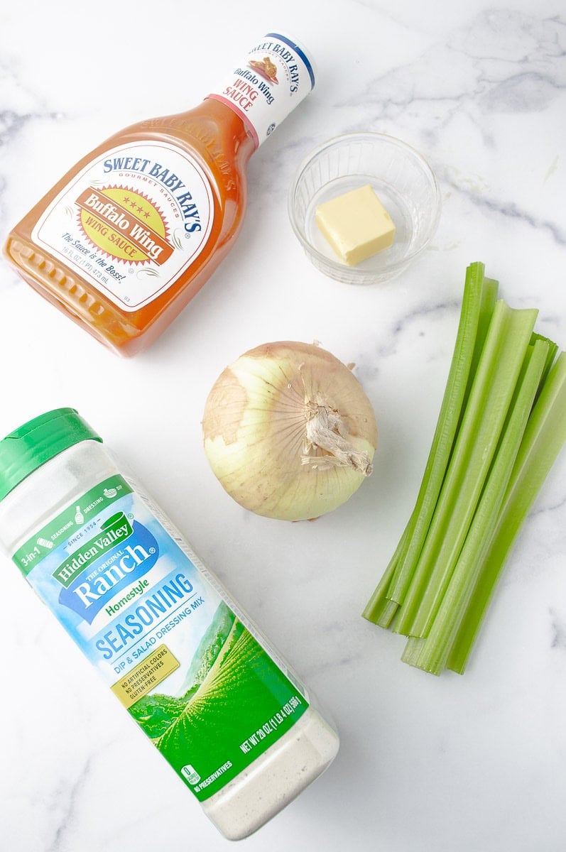 Dive into the bold flavors of Buffalo Chicken Sliders with these essential ingredients for a Crockpot Buffalo Chicken recipe! A bottle of Sweet Baby Ray’s Buffalo Wing Sauce brings the perfect spicy kick, while a stick of butter ensures rich, melt-in-your-mouth tenderness for your Shredded Buffalo Chicken. A whole onion adds depth, and fresh celery stalks provide a crisp contrast. Finish it off with Hidden Valley Ranch seasoning mix to create a creamy, tangy dressing for your Slow Cooker Buffalo Chicken Sliders. This Buffalo Chicken in Crockpot setup makes the ultimate Sliders Recipes Chicken—a must-try for your next gathering!