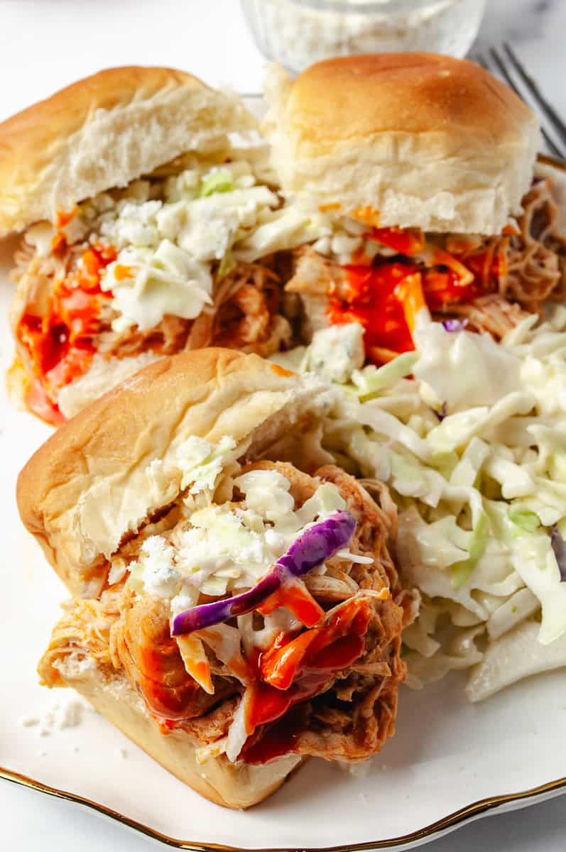 mouthwatering Buffalo Chicken Sliders! Featuring tender Shredded Buffalo Chicken cooked to perfection in a Crockpot Buffalo Chicken Sliders recipe, these Chicken Sliders are topped with creamy blue cheese and crunchy coleslaw, all nestled in soft buns. Perfect for a crowd, this Slow Cooker Buffalo Chicken dish is easy to whip up with a Buffalo Chicken Sliders Crock Pot method. Try this Healthy Buffalo Chicken Sliders recipe today and elevate your game day or family dinner with these irresistible Sliders Recipes Chicken!