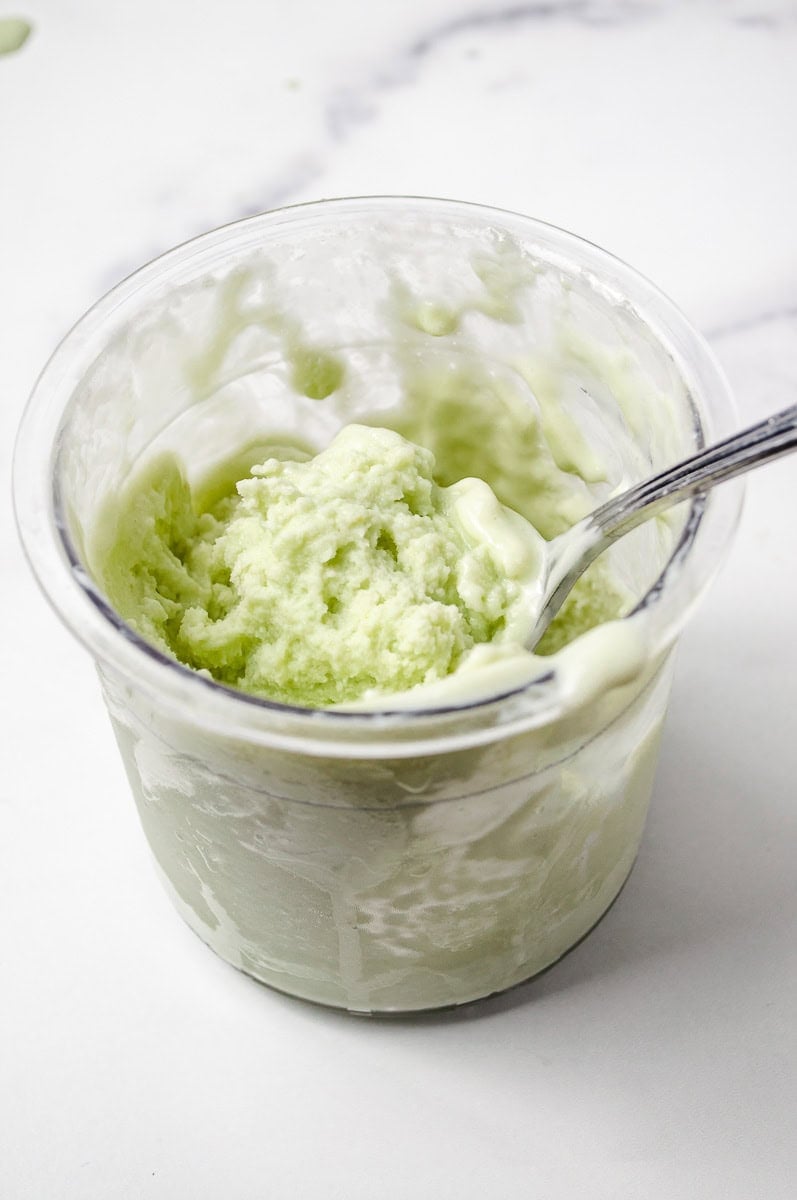 Creamy, churned Pistachio Protein Ice Cream inside a Ninja Creami pint, made with sugar-free pudding, Pistachio Pudding, and unsweetened almond milk. This smooth and healthy dessert is part of a delicious Pistachio Ninja Creami Recipe that fits perfectly into Sugar Free Ice Cream and Healthy Ice Cream Recipes collections.