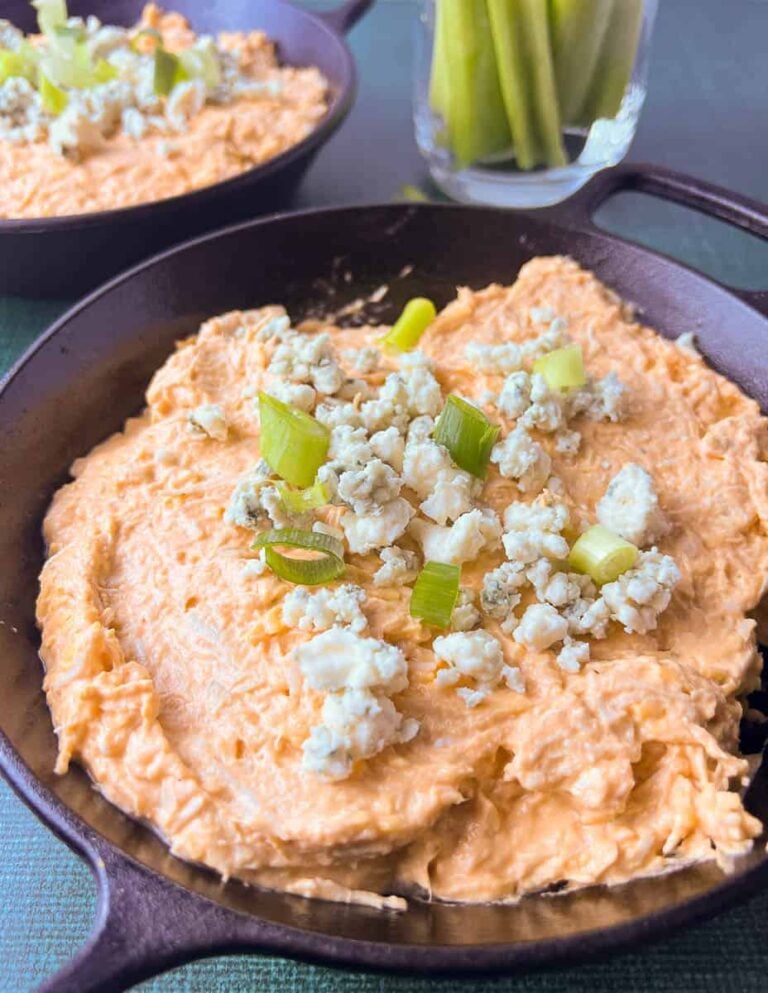 This creamy buffalo chicken dip is loaded with shredded chicken, tangy cream cheese, and a splash of Franks Buffalo sauce for that signature kick. Before baking, it’s topped with crumbled blue cheese and fresh green onions for extra flavor and color. The cast iron skillet helps the chicken buffalo dip bake evenly, giving it that perfect golden edge and gooey center. Whether it’s for game day food or your next party, this easy buffalo chicken dip always impresses with its rich texture and bold, spicy flavor.