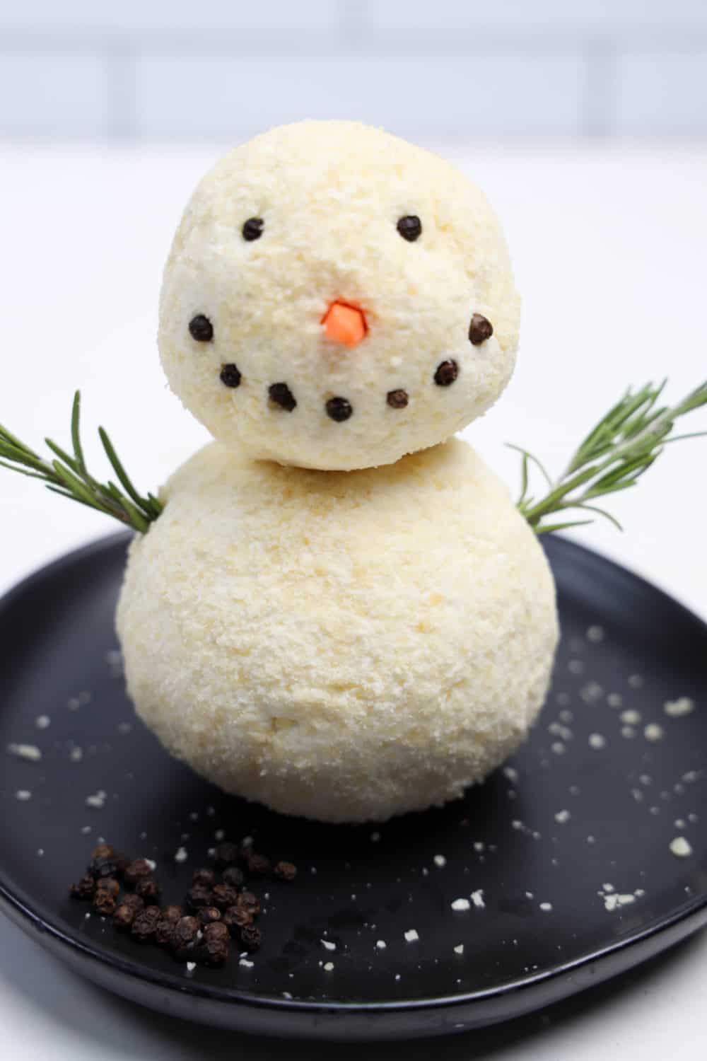 Snowman cheese ball made with cream cheese, perfect for holiday appetizers and cheese ball recipes easy enough for festive parties.