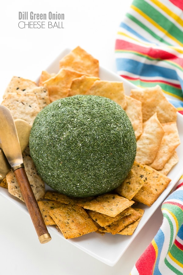 Dill Green Onion Cheese Ball coated in dried dill, served with assorted crackers β a fresh and easy option for cheese ball recipes easy and flavorful appetizers for party.