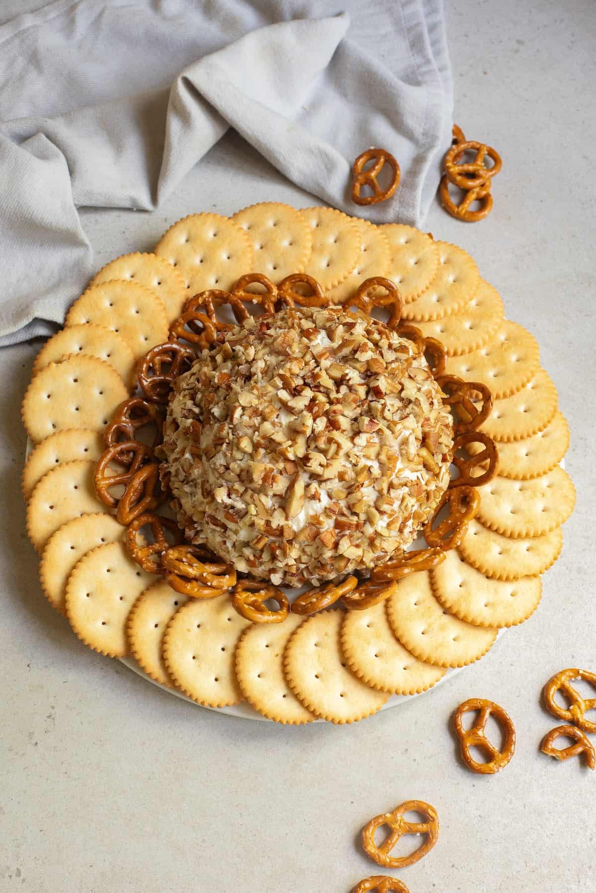 Ranch Chicken Cheese Ball rolled in chopped nuts and surrounded by crackers and pretzels a flavorful, crowd-pleasing option for cheese ball recipes easy and tasty appetizers easy finger food.