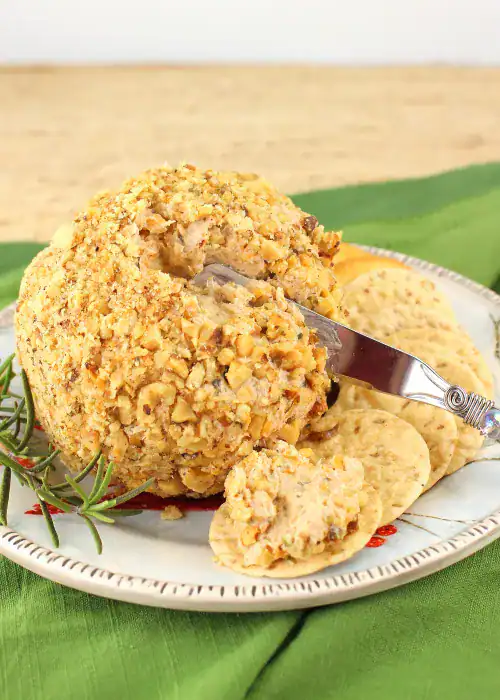 Guinness and Caramelized Onion Cheese Ball coated in chopped walnuts and served with crackers a bold and savory pick among holiday cheese balls and unique cheese ball recipes.