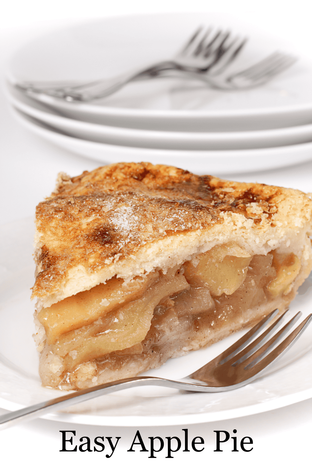 Easy homemade American apple pie slice on a white plate with a fork showing the golden flaky crust and thick cinnamon spiced apple filling