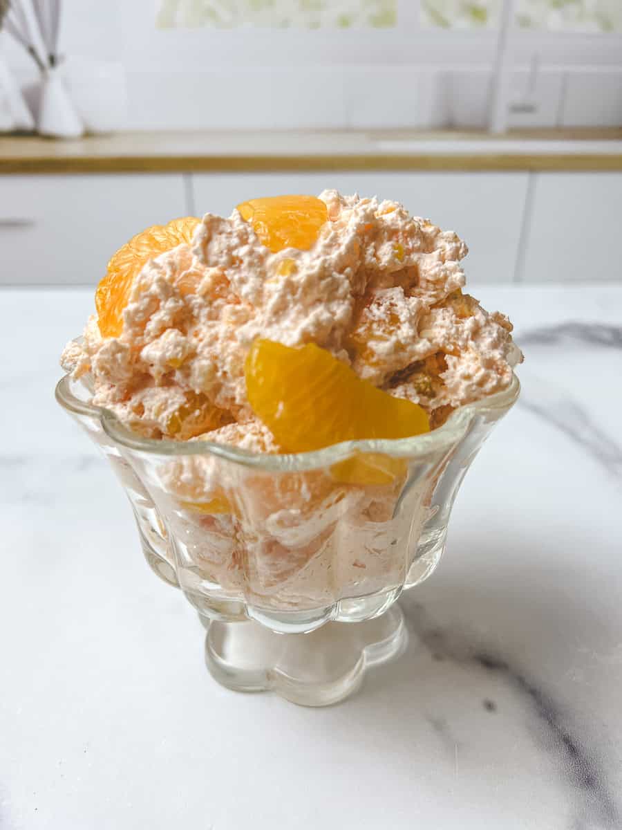 Jello salad recipes with cool whip, this orange fluff jello salad recipe served in a glass dessert cup