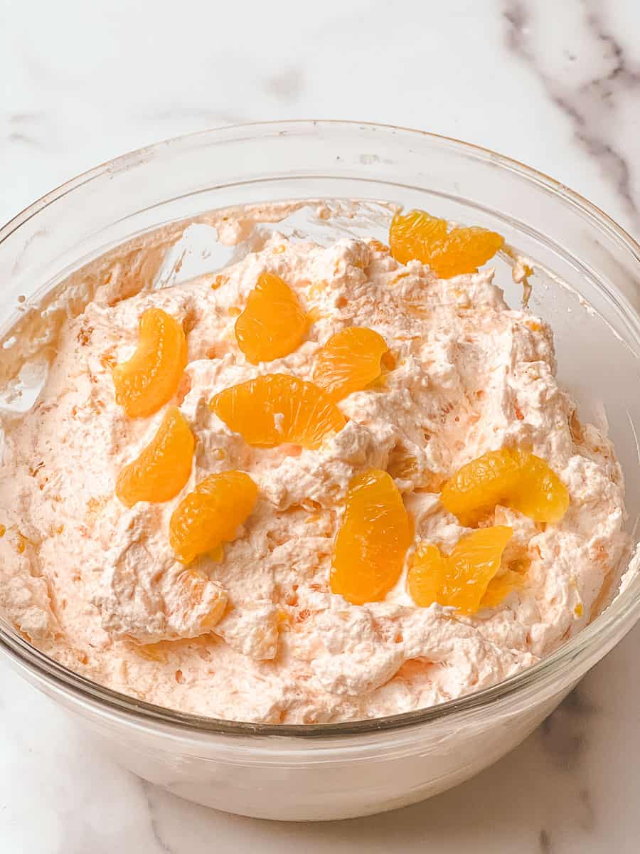 Orange fluff salad mandarin oranges in a bowl, ready for this orange fluff jello salad recipe