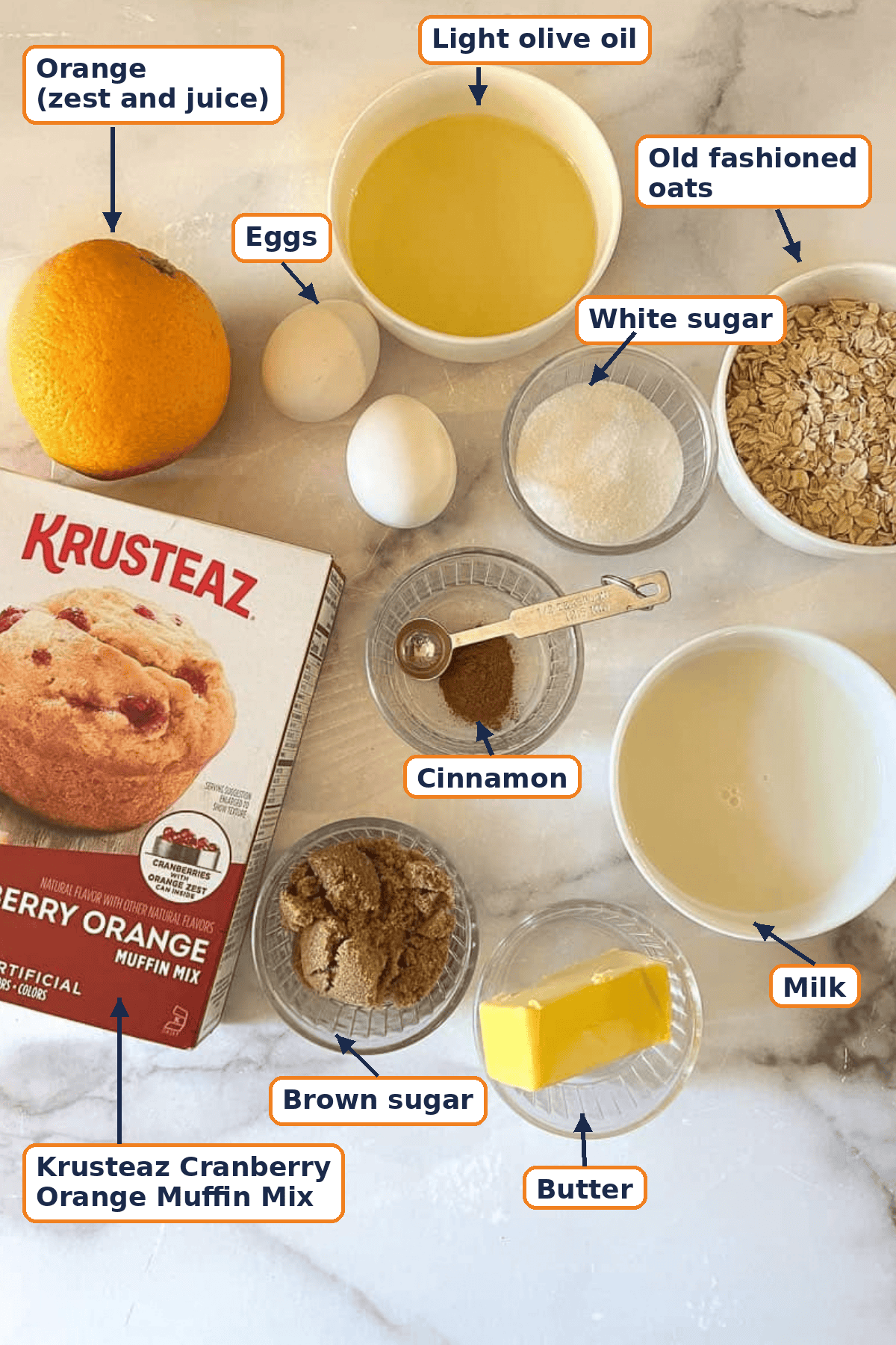 Ingredients for easy cranberry orange muffins with streusel, including Krusteaz muffin mix, orange, eggs, olive oil, milk, oats, sugars, cinnamon, and butter.